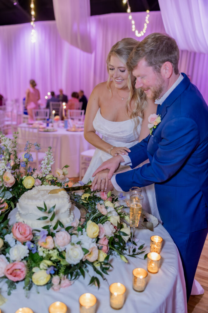 Bride and Groom cutting cake at a wedding in Starkville, Mississippi at The Hill and Moor.