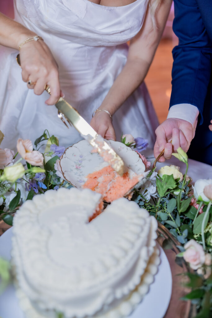 Bride and Groom cutting cake at a wedding in Starkville, Mississippi at The Hill and Moor.